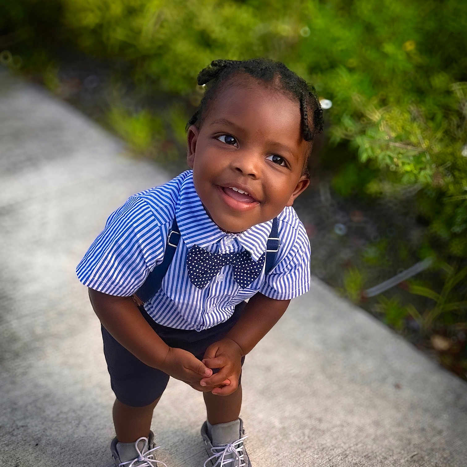 Liam is registered to the contest to win money with this photo: accessories, child, clothing, face, female, footwear, formalwear, girl, happy, head, person, photography, portrait, shoe, shorts, sitting, smile, sneaker, standing, tie