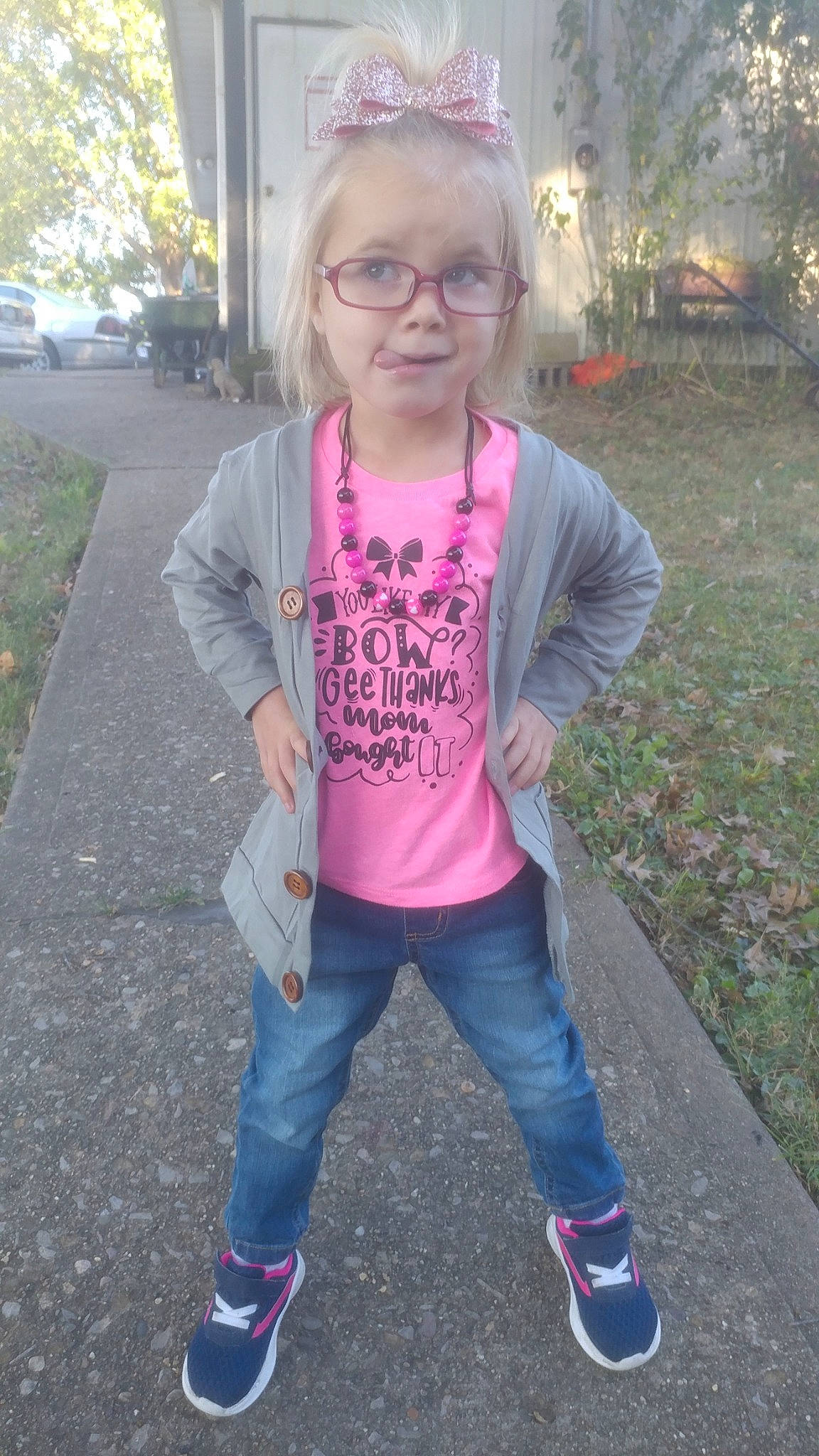 Anika is registered to the contest to win money with this photo: child, cool, footwear, fun, glasses, jeans, person, pink, sleeve, smile, t_shirt, toddler, top, tree