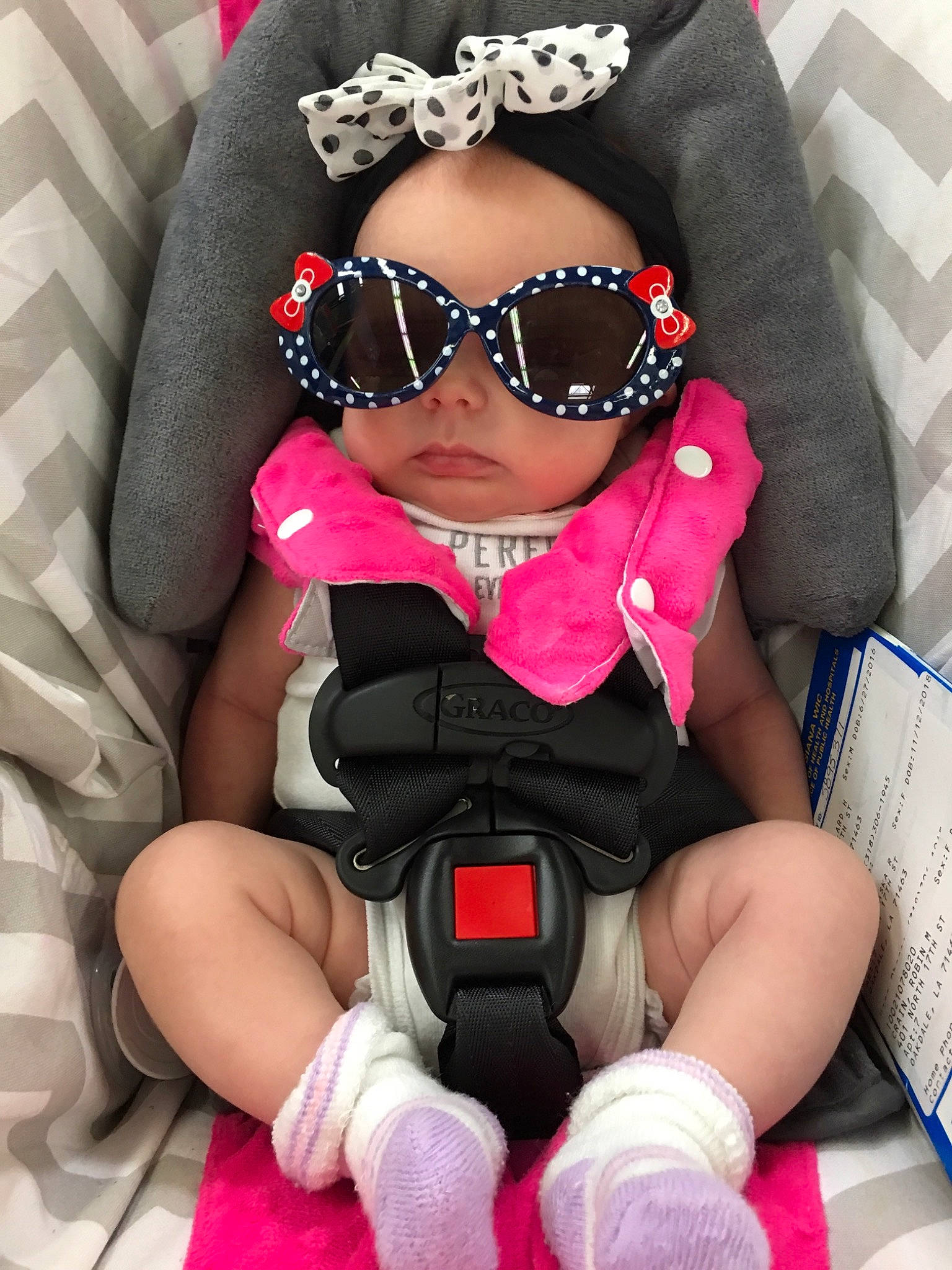 Alaska is registered to the contest to win money with this photo: car_seat, child, eyewear, girl, glasses, headwear, person, pink, product, toddler, vision_care
