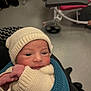 newborn, baby, knit_hat, knit_sweater, blue_blanket, infant, wrapped, indoor, hospital, medical_equipment, red_chair, person, cute, face, young_child, holding, portrait, warm, soft, human