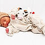 Maïlhow a rejoint le concours — aidez-le/la à gagner de superbes lots ! newborn, baby, sleeping, plush_toy, cow_toy, hat, beige_clothing, onesie, infant, cute, peaceful, soft_texture, white_background, cozy, child, portrait, sleep, hand, face, bed