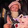 baby, car_seat, infant, child, pink_hat, plush_toy, straps, safety_belt, cute, small_hand, soft_toy, indoor, closeup, seat, child_protection, serious_face, infant_clothing, car_safety, captive, adorable