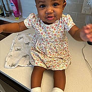 True joined the competition — help win amazing prizes! baby, child, cloth, countertop, curious_expression, cute, face, floral_dress, girl, headband, home, indoor, kitchen, outstretched_arms, person, sink, smile, socks, tap, zebra_pattern