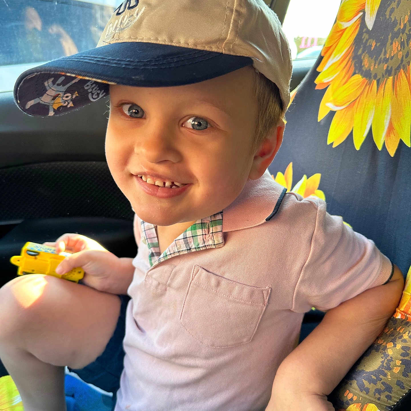 Christian is registered to the contest to win money with this photo: baby, baseballcap, bodypart, cap, car, clothing, face, finger, footwear, hand, hat, head, person, photography, portrait, shoe, shorts, toy, transportation, vehicle