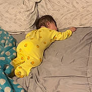 Isabella joined the competition — help win amazing prizes! baby, yellow_onesie, sleeping, bed, pillow, blanket, polka_dot, blue_blanket, orange_prints, infant, indoor, resting, soft_fabric, child, toddler, cozy, nap, bedroom, comfort, peaceful