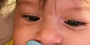 Isabella joined the competition — help win amazing prizes! baby, pacifier, face, child, yellow_clothing, closeup, infant, skin, hair, eyes, mouth, cute, young, indoors, person, portrait, childhood, baby_girl, baby_boy, calm