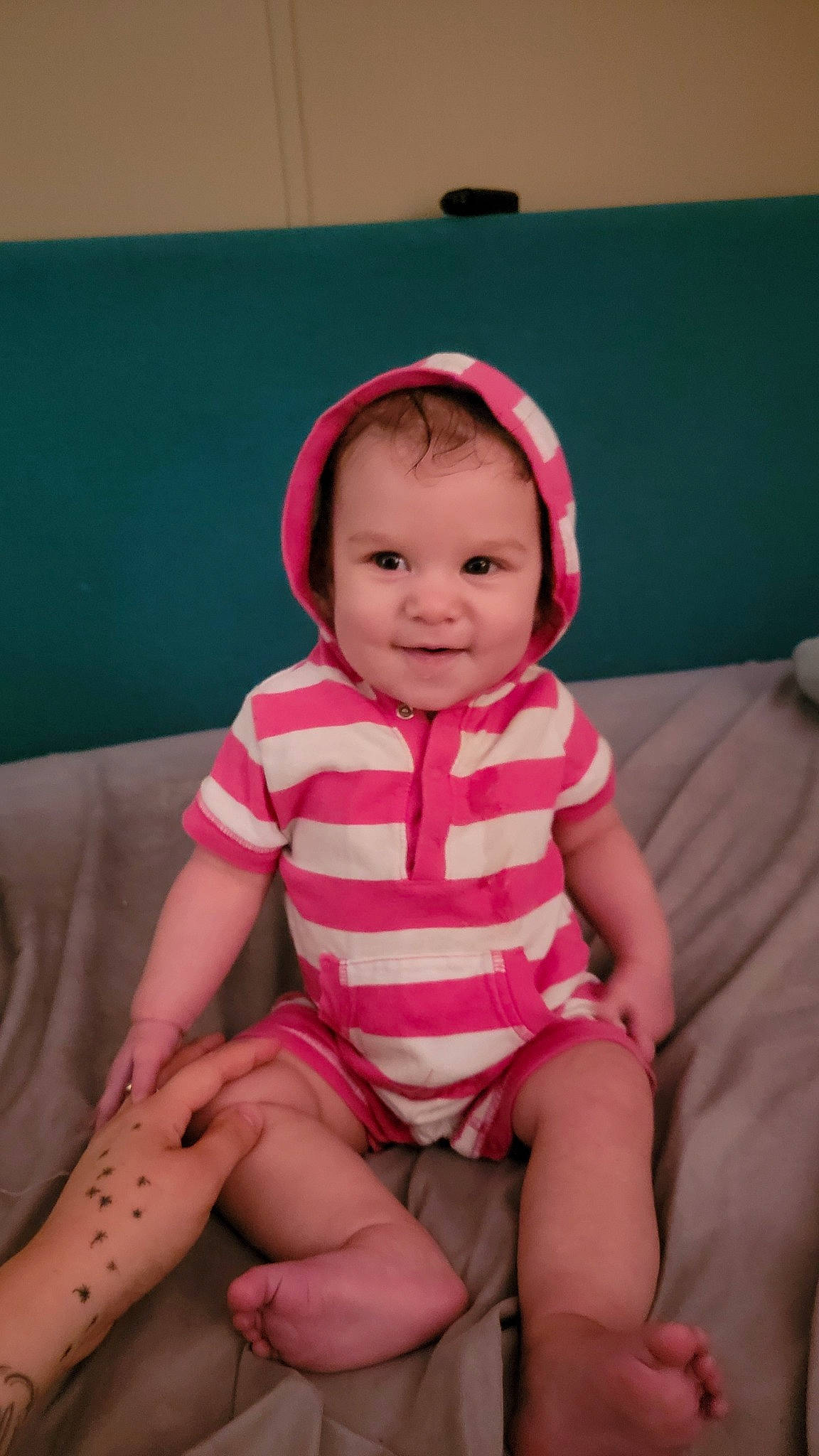 Soleil is registered to the contest to win money with this photo: baby, baby_toddler_clothing, cheek, child, comfort, eye, finger, happy, head, headwear, human_leg, joy, lap, magenta, person, pink, shorts, sitting, skin, sleeve