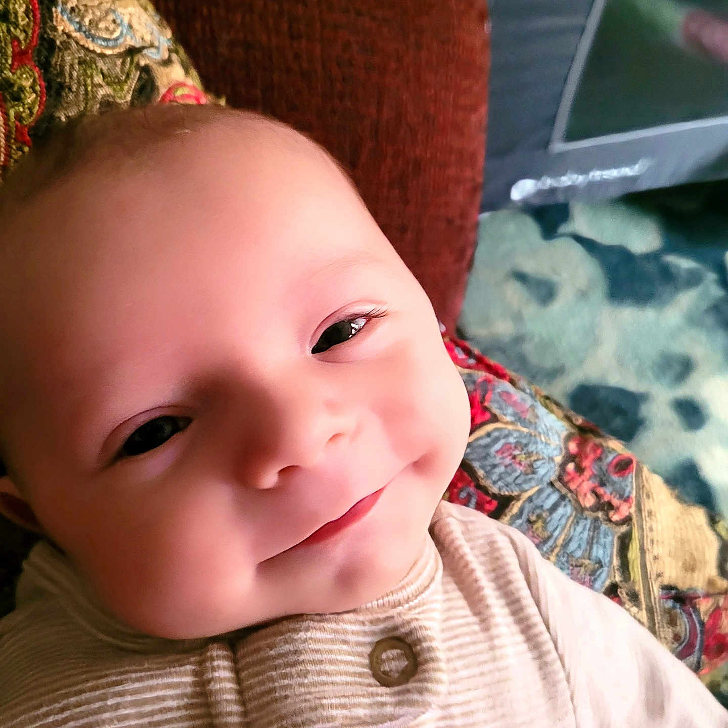 Weston is registered to the contest to win money with this photo: baby, bodypart, clothing, couch, cushion, face, finger, furniture, hand, happy, hat, head, homedecor, knitwear, newborn, person, photography, portrait, smile, sweater