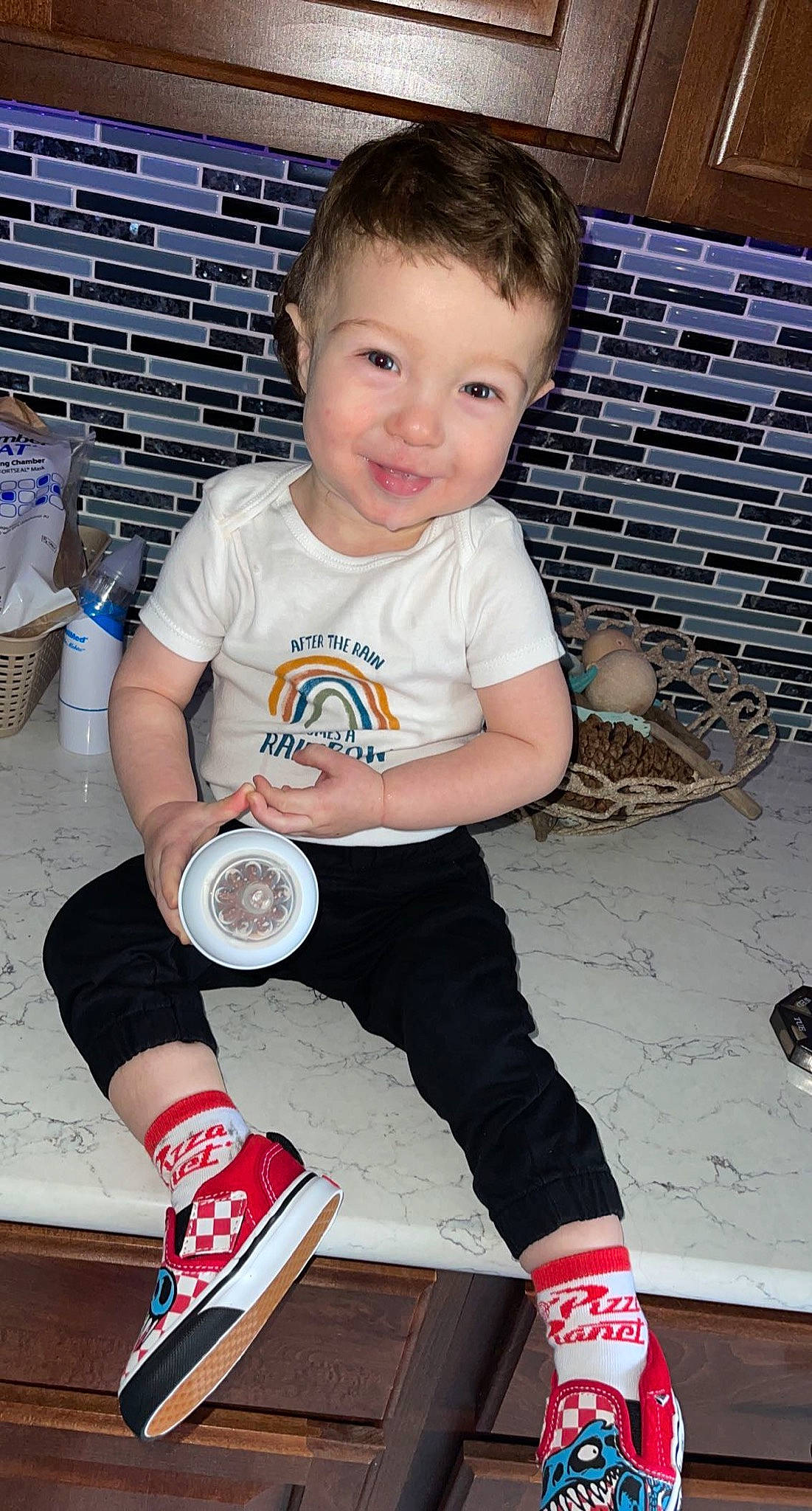 Brantley is registered to the contest to win money with this photo: baby_toddler_clothing, blue, carmine, child, design, flash_photography, fun, happy, human_leg, joy, knee, pattern, person, sitting, sleeve, smile, sock, sportswear, t_shirt, thigh