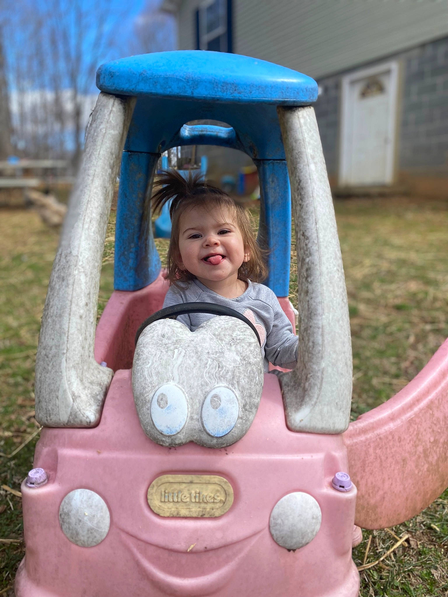 Payton joined the competition — help win amazing prizes! automotive_design, automotive_exterior, automotive_tire, blue, bumper, dress, grass, happy, head, jacket, joy, leisure, motor_vehicle, person, photograph, plant, smile, tire, toddler, tree