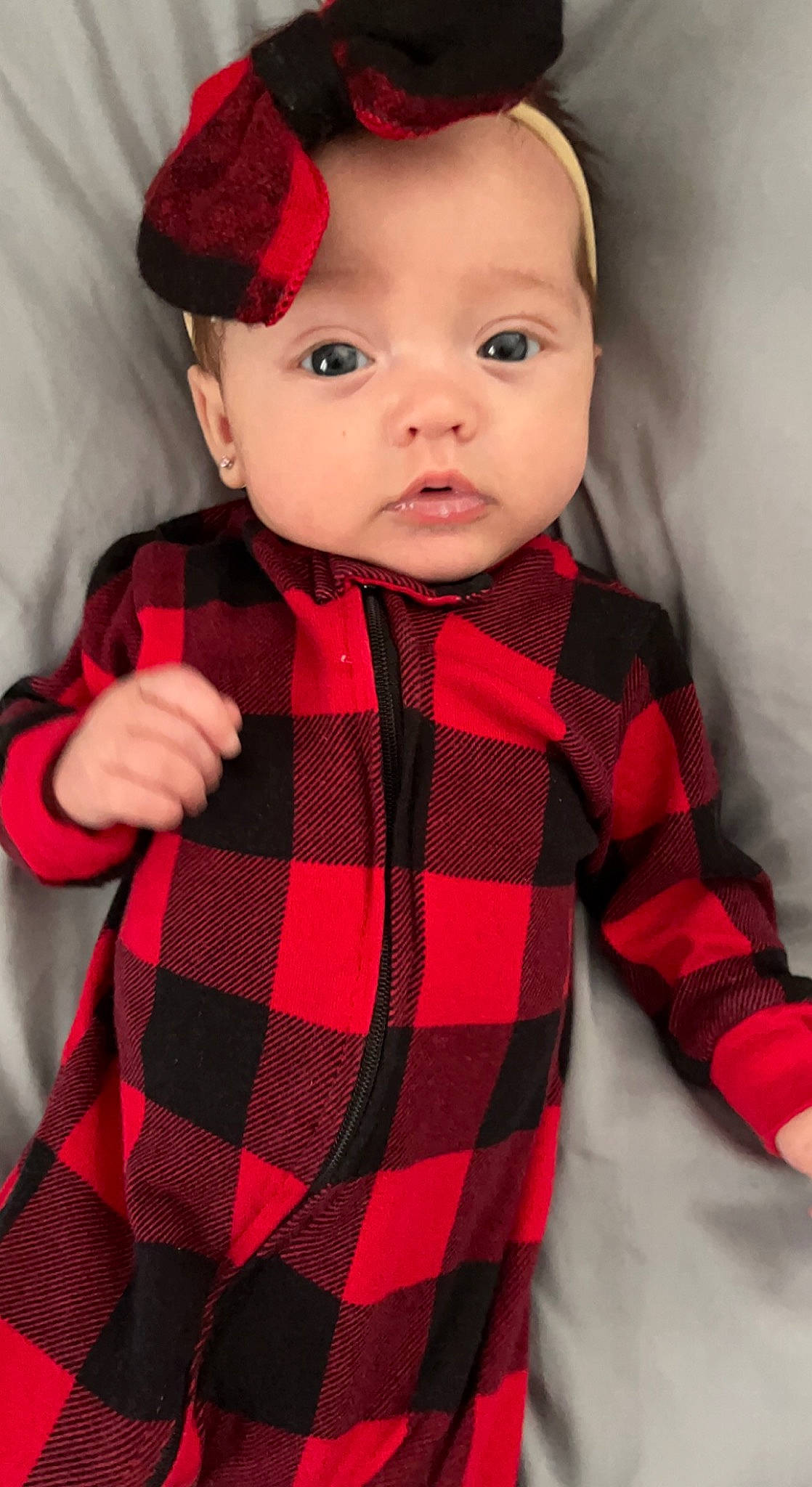 Ensley is registered to the contest to win money with this photo: baby, baby_toddler_clothing, black, cap, child, clothing, collar, hat, head, lip, neck, outerwear, pattern, person, plaid, red, skin, sleeve, tartan, textile