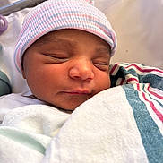Tiera joined the competition — help win amazing prizes! newborn, baby, sleeping, hospital, blanket, cap, infant, closeup, face, peaceful, wrapped, soft_lighting, portrait, cute, child, resting, toddler, skin, headwear, indoors