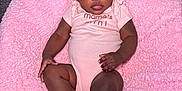 Kaylee is registered to the contest to win money with this photo: baby, infant, child, pink_blanket, onesie, hair_bows, cute, curious_eyes, indoor, carpet, relaxed, portrait, person, skin, feet, hands, smile, cozy, soft_texture, floor
