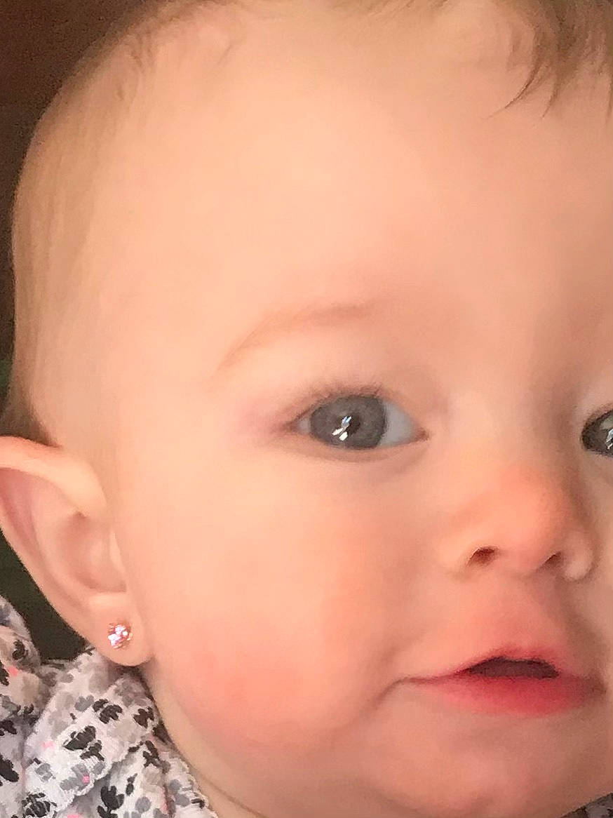 Carolina is registered to the contest to win money with this photo: baby, cheek, chin, dress, ear, eyebrow, eyelash, face, facial_expression, finger, forehead, iris, jaw, lip, mouth, neck, nose, organ, person, skin