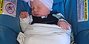 Jaylyn joined the competition — help win amazing prizes! baby, newborn, infant, sleeping, car_seat, swaddle, hat, pacifier, blanket, safety_harness, seat_belt, warning_label, fabric, portrait, closeup, indoor, cute, peaceful, hospital, child