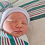 Jaylyn joined the competition — help win amazing prizes! newborn, baby, infant, sleeping, swaddled, striped_blanket, hospital, beanie, hat, closeup, face, cheeks, lips, peaceful, bedding, medical_form, portrait, skin, nursery, postpartum
