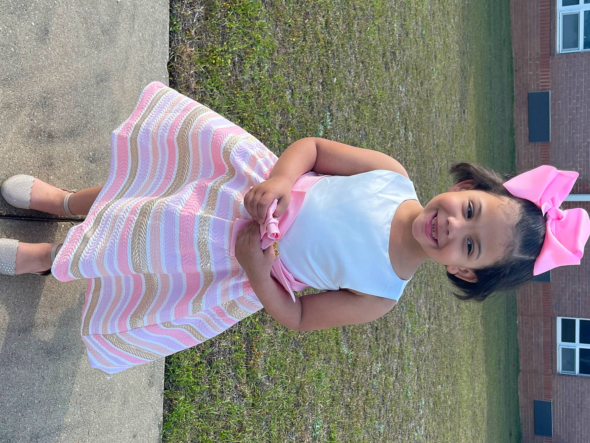 Hadassah is registered to the contest to win money with this photo: child, foot, fun, grass, happy, human_leg, joy, knee, leisure, magenta, pattern, people_in_nature, person, pink, plaid, plant, sandal, smile, summer, thigh