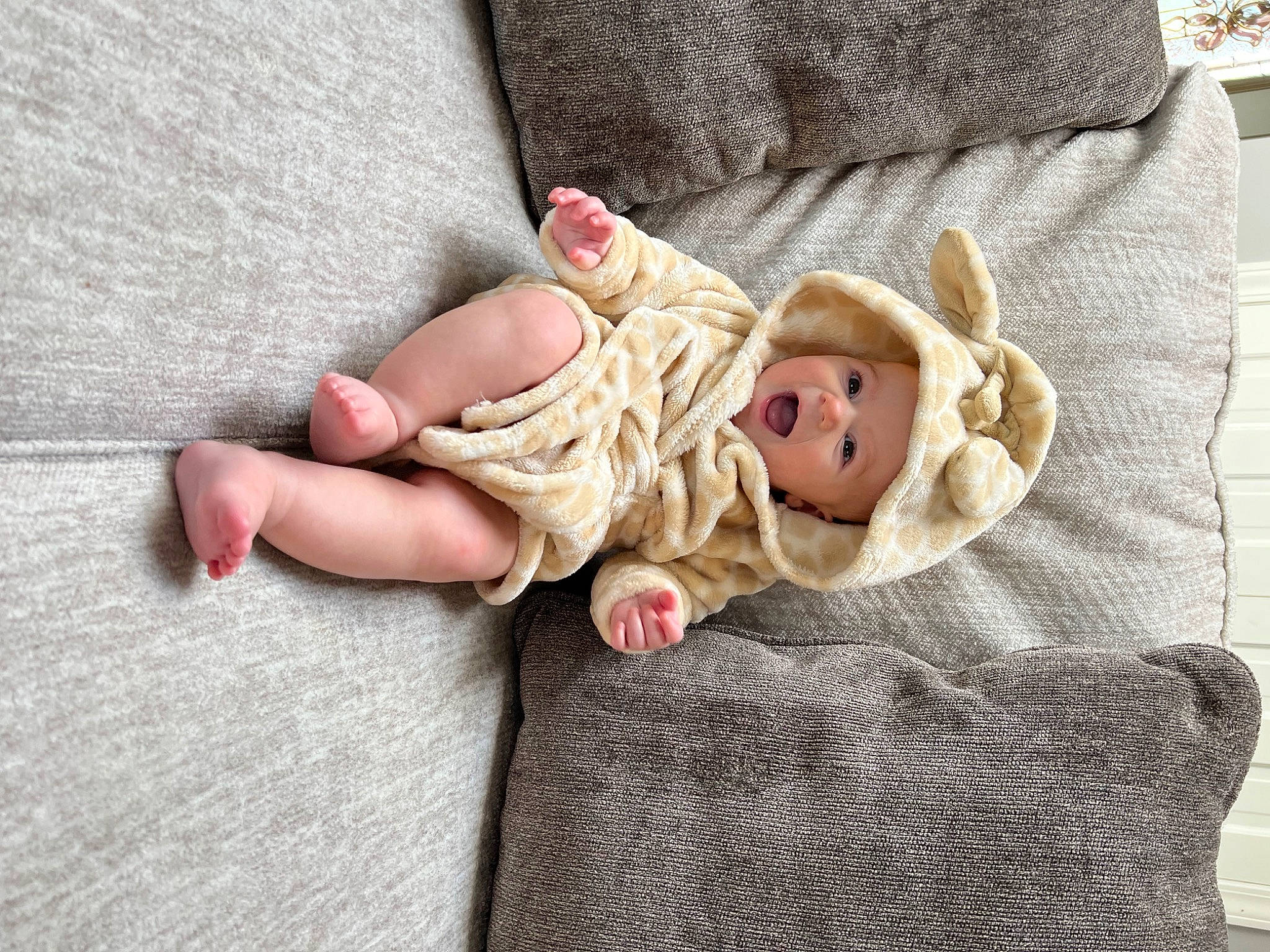 Kali is registered to the contest to win money with this photo: bedding, comfort, doll, eye, fawn, finger, foot, fur, hat, head, headwear, human_leg, leg, linens, person, sitting, stuffed_toy, teddy_bear, textile, toy