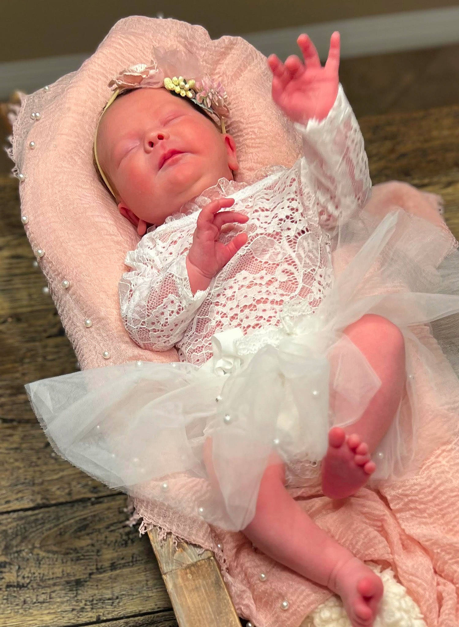 Raelynn is registered to the contest to win money with this photo: baby, baby_toddler_clothing, bridal_accessory, child, comfort, dress, embellishment, fashion_accessory, hair_accessory, happy, headgear, headpiece, human_body, peach, person, petal, pink, sitting, skin, sleeve