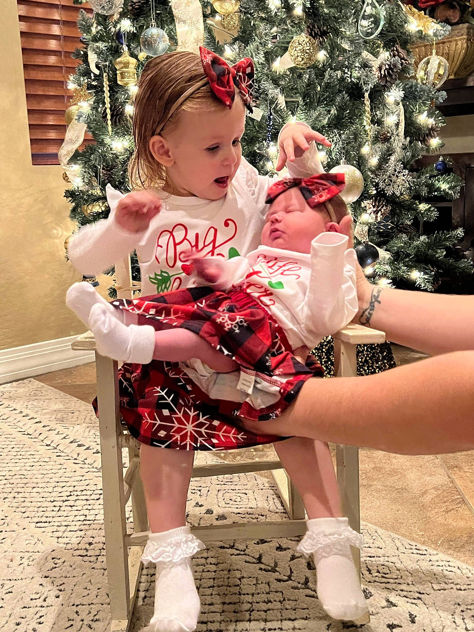 Paige joined the competition — help win amazing prizes! baby_toddler_clothing, child, christmas_decoration, christmas_tree, dress, event, fashion_design, happy, human_body, human_leg, knee, lap, leg, person, pink, plant, red, shoe, sock, thigh