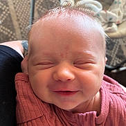 Echo is registered to the contest to win money with this photo: baby, newborn, smiling, face, person, infant, clothing, pink, arm, resting, indoors, closeup, cute, skin, head, human, happy, sleepy, child, portrait