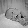 Echo is registered to the contest to win money with this photo: baby, infant, black_and_white, blanket, cute, face, skin, newborn, expression, portrait, lying_down, soft_texture, hand, mouth_open, sleepy, close_up, child, gentle, peaceful, toddler