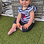 Loris a rejoint le concours — aidez-le/la à gagner de superbes lots ! toddler, child, smile, sitting, grass, artificial_grass, striped_shirt, bunny_design, polka_dot_pants, pink_socks, wicker_chair, outdoor, playful, happy, young_child, short_hair, patterned_rug, casual_clothing, cute, portrait
