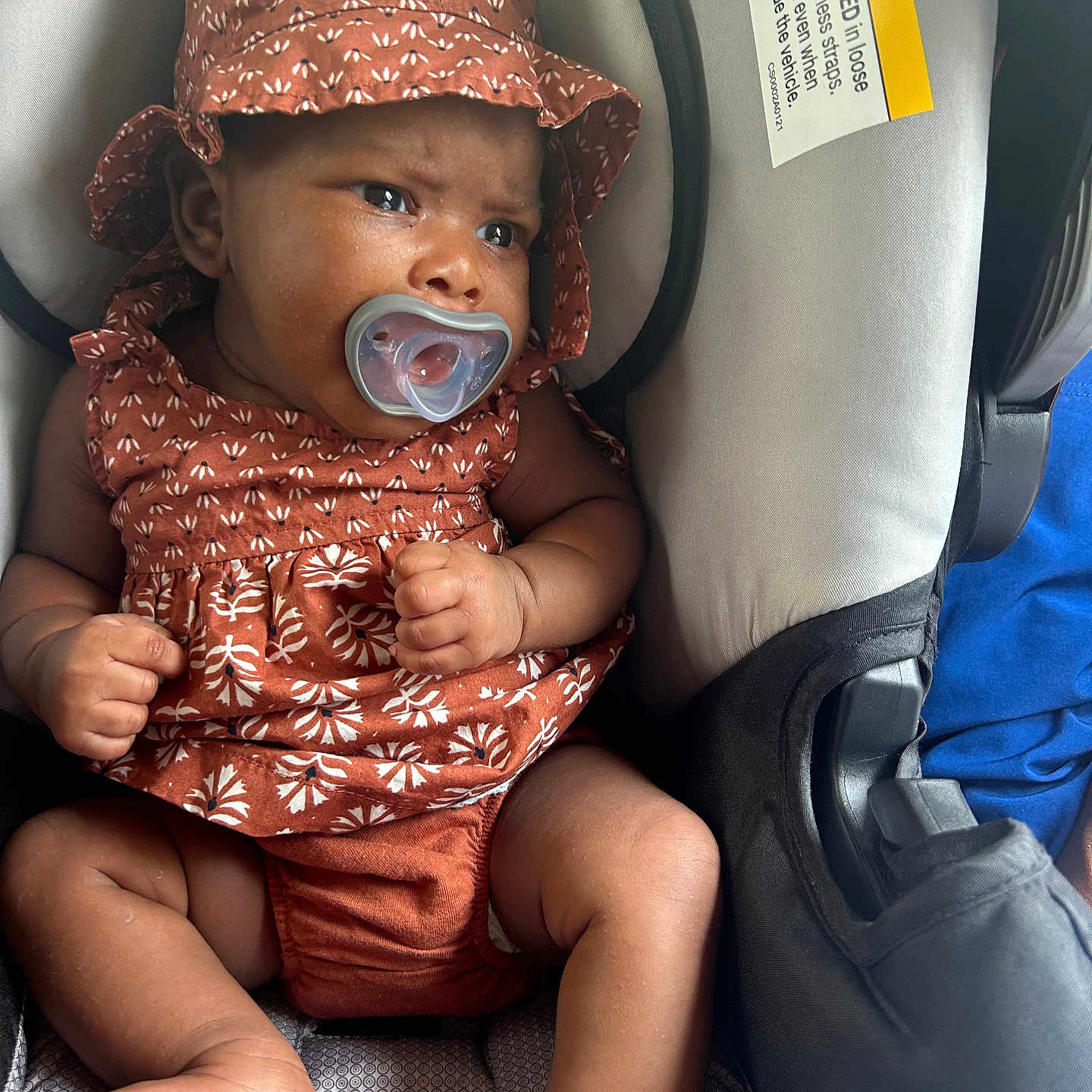 Ivy is registered to the contest to win money with this photo: baby, bodypart, bonnet, cap, car, clothing, cushion, face, finger, hand, hat, head, homedecor, person, photography, portrait, sitting, sunhat, transportation, vehicle