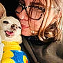 Señor Gomez participe au concours pour gagner de l'argent avec cette photo : woman, dog, glasses, sweater, yellow, blue, close_up, indoor, pet, cute, affection, snuggle, portrait, happy, small_dog, cozy, face, eyewear, clothing, warm
