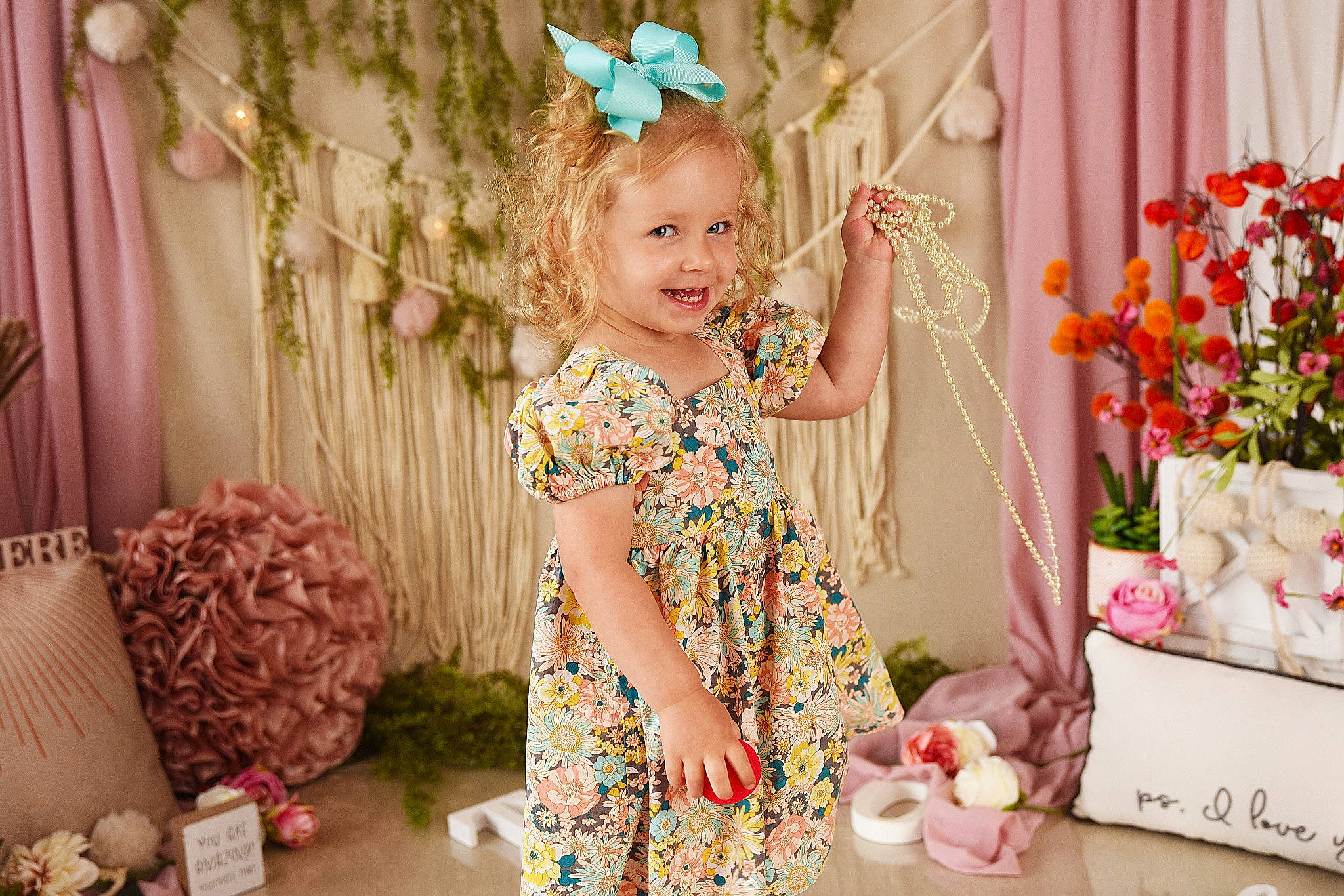 Matilda is registered to the contest to win money with this photo: baby_toddler_clothing, child, curtain, dress, event, flower, flower_arranging, happy, headpiece, insect, joy, magenta, party_supply, pattern, peach, person, petal, pink, plant, smile