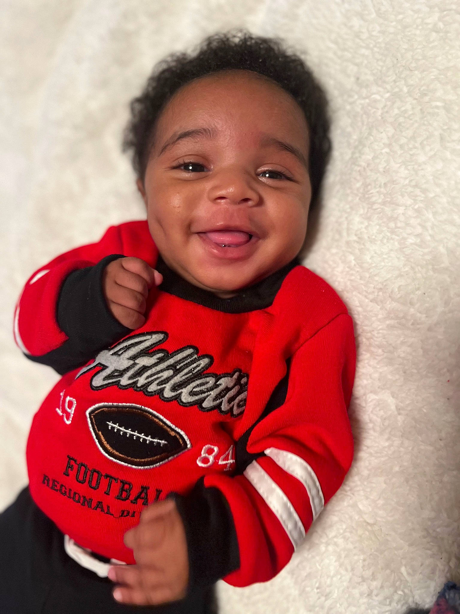 Kyree joined the competition — help win amazing prizes! baby_toddler_clothing, carmine, cheek, child, comfort, elbow, flash_photography, football, fun, gesture, happy, human_body, lip, nose, person, personal_protective_equipment, sleeve, smile, t_shirt, thumb