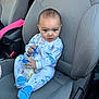 Leighton is registered to the contest to win money with this photo: baby, child, car_seat, pacifier, bottle, pajamas, whale_pattern, clothing, footwear, blue, gray, car_interior, seat, infant, young_child, person, cute, indoors, sitting, expression