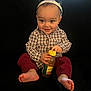 Leighton is registered to the contest to win money with this photo: toddler, child, smile, happy_new_year, headband, plaid_shirt, red_pants, barefoot, bottle, yellow_cap, sitting, black_background, cute, portrait, indoor, baby, celebration, holiday, young_child, person
