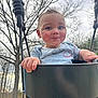 baby, child, swing, playground, outdoor, trees, sky, black_swing, clothing, cute, happy, person, infant, holding, park, nature, face, hands, curly_hair, rosy_cheeks