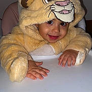 Manny a rejoint le concours — aidez-le/la à gagner de superbes lots ! child, toddler, baby, lion_costume, hood, high_chair, hands, smile, eyes, cheeks, indoor, portrait, plush, furry, costume, table, seat, cute, flash, happy