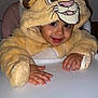 child, toddler, baby, lion_costume, hood, high_chair, hands, smile, eyes, cheeks, indoor, portrait, plush, furry, costume, table, seat, cute, flash, happy