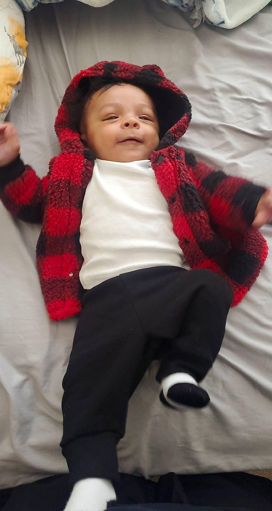 Denis is registered to the contest to win money with this photo: baby, cheek, child, headwear, outerwear, pattern, person, plaid, red, skin, sleeve, smile, textile, toddler, wool