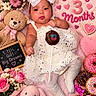 Ivy is registered to the contest to win money with this photo: baby, infant, child, girl, portrait, lying_down, smiling, bow, dress, tights, flowers, teddy_bear, stuffed_bunny, doughnuts, candy, cupcake, birthday, pink, blanket, indoor