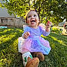 child, toddler, grass, tree, sunlight, smile, happy, dress, boots, outdoor, nature, backyard, greenery, person, daylight, cute, playing, young, sunshine, fun