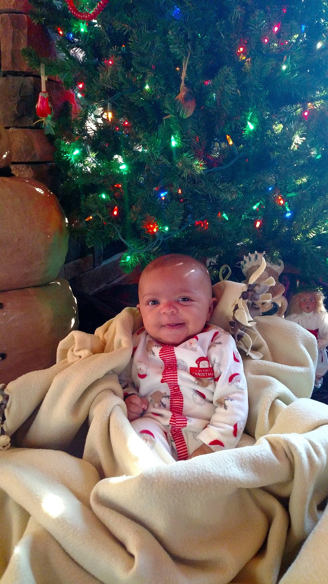 Zion is registered to the contest to win money with this photo: child, christmas, christmas_decoration, christmas_ornament, christmas_tree, event, fun, girl, holiday, infant, person, smile, toddler