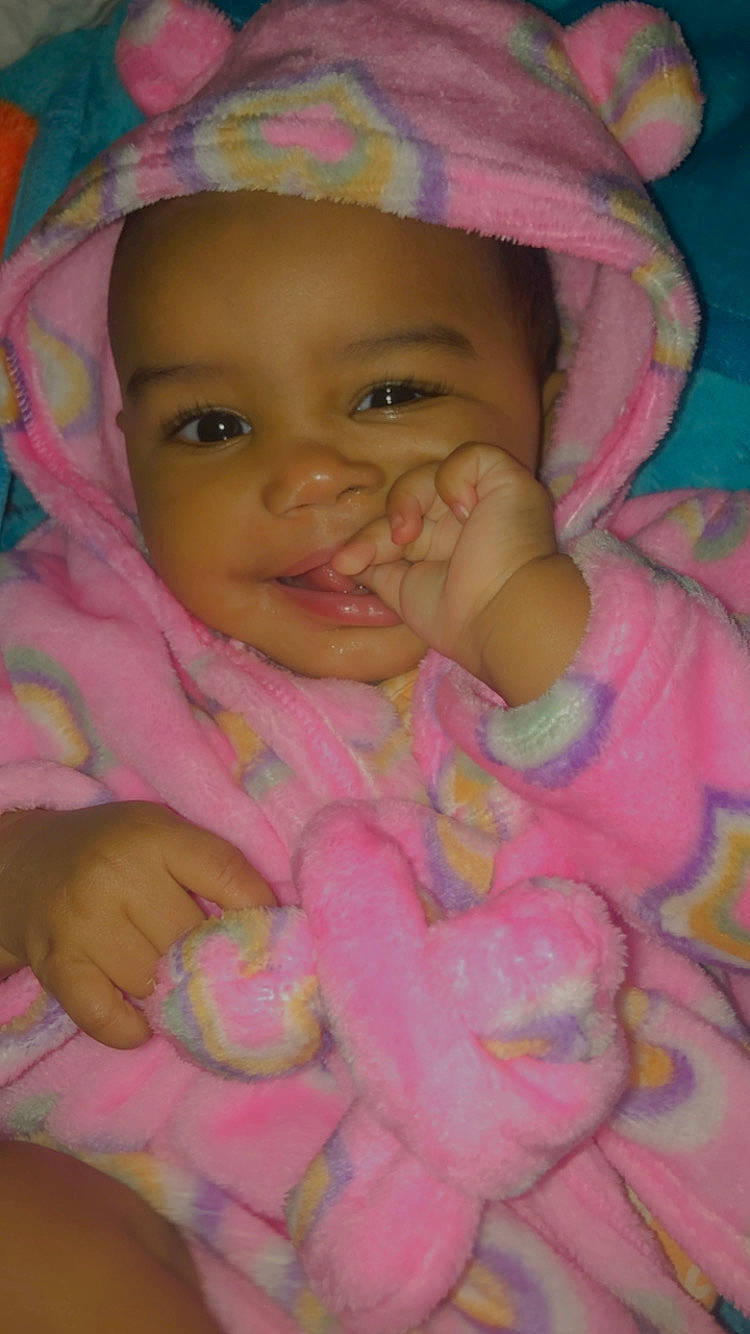 Zendaya is registered to the contest to win money with this photo: baby, cheek, chin, eye, eyebrow, face, facial_expression, gesture, happy, headwear, iris, lip, mouth, nose, organ, person, photograph, product, skin, smile