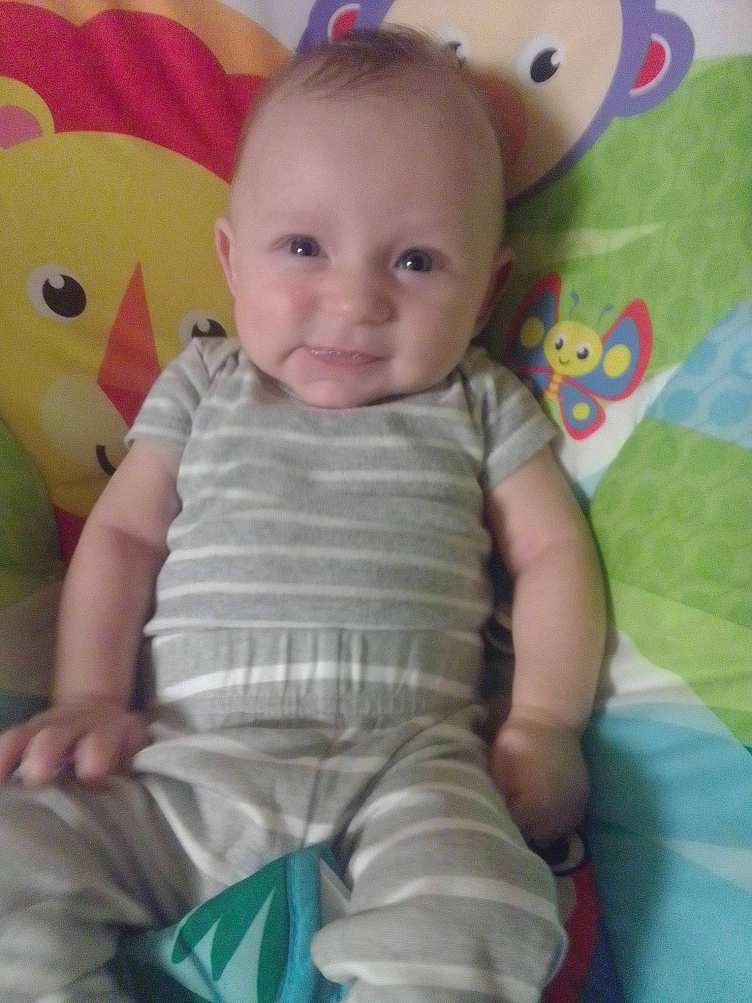 James is registered to the contest to win money with this photo: baby, baby_toddler_clothing, cheek, child, chin, fun, green, happy, iris, mammal, nose, organ, person, photograph, pink, product, skin, sleeve, smile, textile