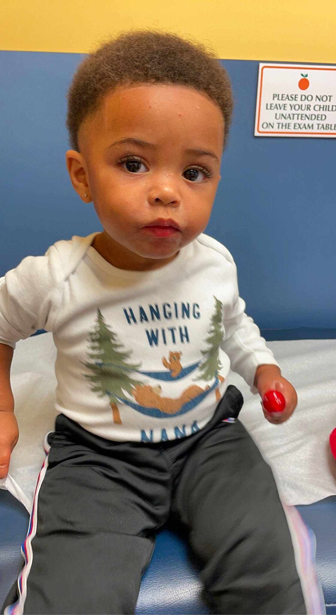 Evan is registered to the contest to win money with this photo: arm, baby, baby_toddler_clothing, cheek, child, face, facial_expression, finger, gesture, happy, head, human, joint, nose, organ, person, product, skin, sleeve, standing