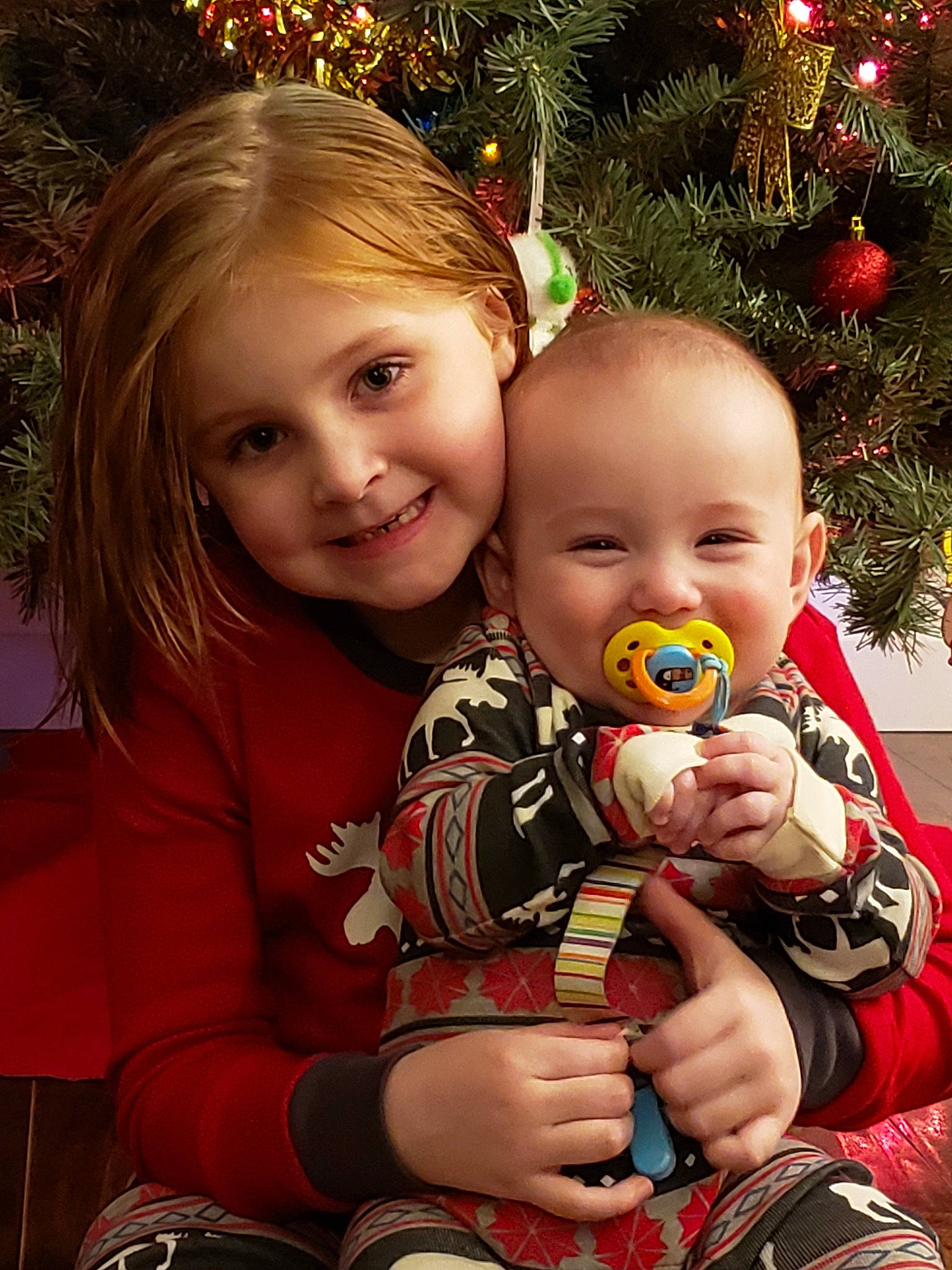 Gemma Cottrell is registered to the contest to win money with this photo: child, christmas, christmas_decoration, christmas_eve, christmas_ornament, christmas_tree, happy, holiday, joy, person, sibling, skin, smile, toddler, tree