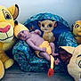 Kayden participe au concours pour gagner de l'argent avec cette photo : baby, plush_toy, lion_king, stuffed_animal, child, knitted_hat, knitted_diaper_cover, armchair, floor, wood_flooring, toy, yellow, blue, pattern, indoor, cute, infant, smiling_toy, decor, relaxing