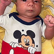 Kayden participe au concours pour gagner de l'argent avec cette photo : baby, infant, mickey_mouse, onesie, clothing, towel, pacifier, toy, hand, face, skin, bed, sleepwear, child, newborn, cute, portrait, lying_down, indoor, person
