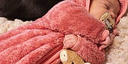 Kiara is registered to the contest to win money with this photo: baby, sleeping_baby, infant, pacifier, plush_toy, stuffed_animal, pink_hoodie, blanket, fur_blanket, soft_texture, cozy, newborn, hand, bedding, portrait, cat, black_cat, pet, sleeping, closeup