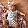 arm, baby, blanket, child, chubby, cozy, cute, face, happy, headband, hello_kitty, indoors, infant, leg, lying_down, onesie, pink, skin, smiling, soft_texture