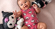 Kiara joined the competition — help win amazing prizes! baby, child, chubby_cheeks, cozy, cute, foot, hand, happy, hello_kitty, indoor, infant, lying_down, pink_onesie, playful, plush_toy, portrait, smiling, soft_blanket, stuffed_animal, toddler