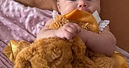 Kiara joined the competition — help win amazing prizes! baby, infant, teddy_bear, blanket, headband, flower_pattern, soft_texture, cute, child, indoors, cozy, smiling, portrait, holding, plush_toy, closeup, sleepwear, bed, comfort, happy